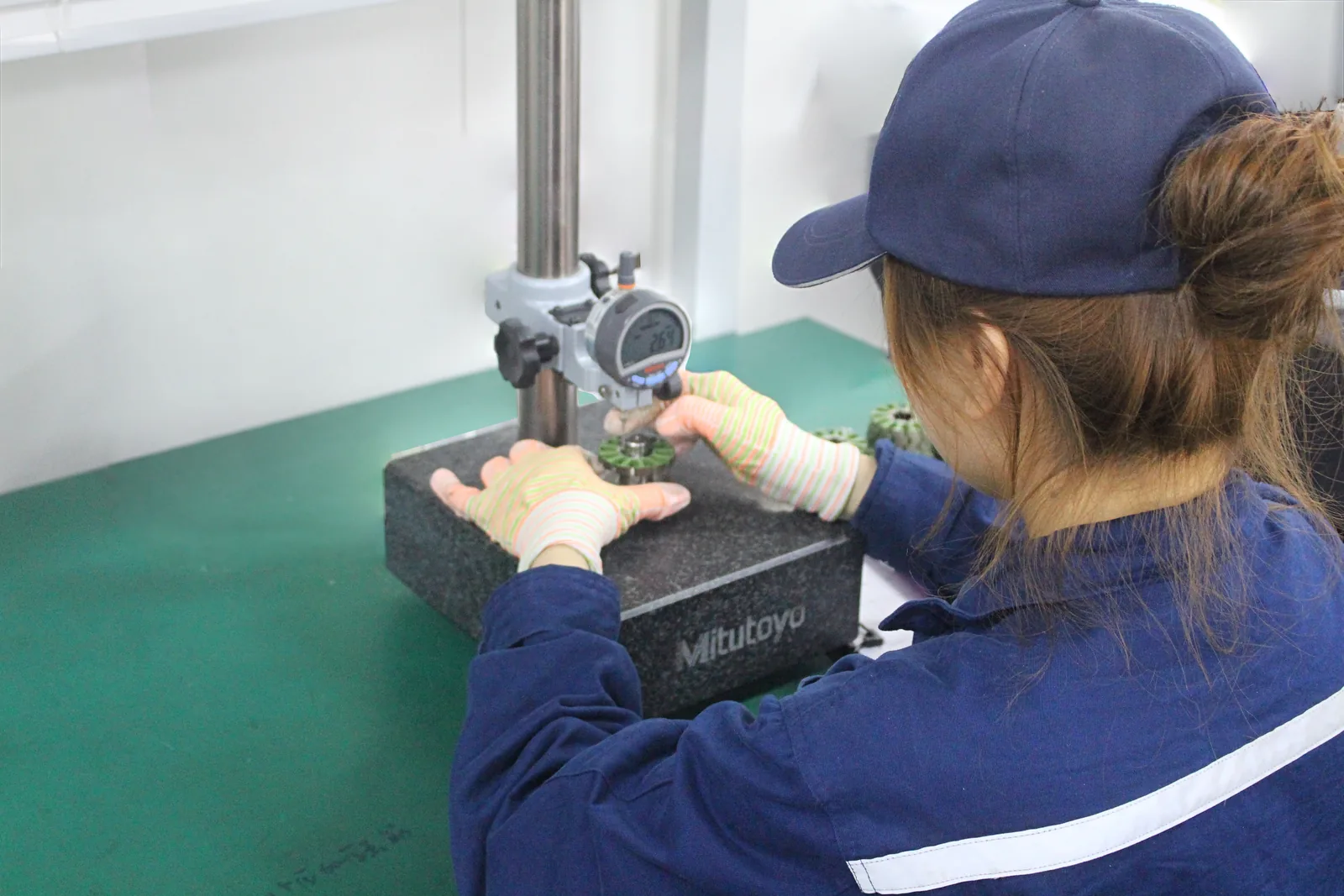 Checking stack height with a digital height gauge on a granite surface plate.